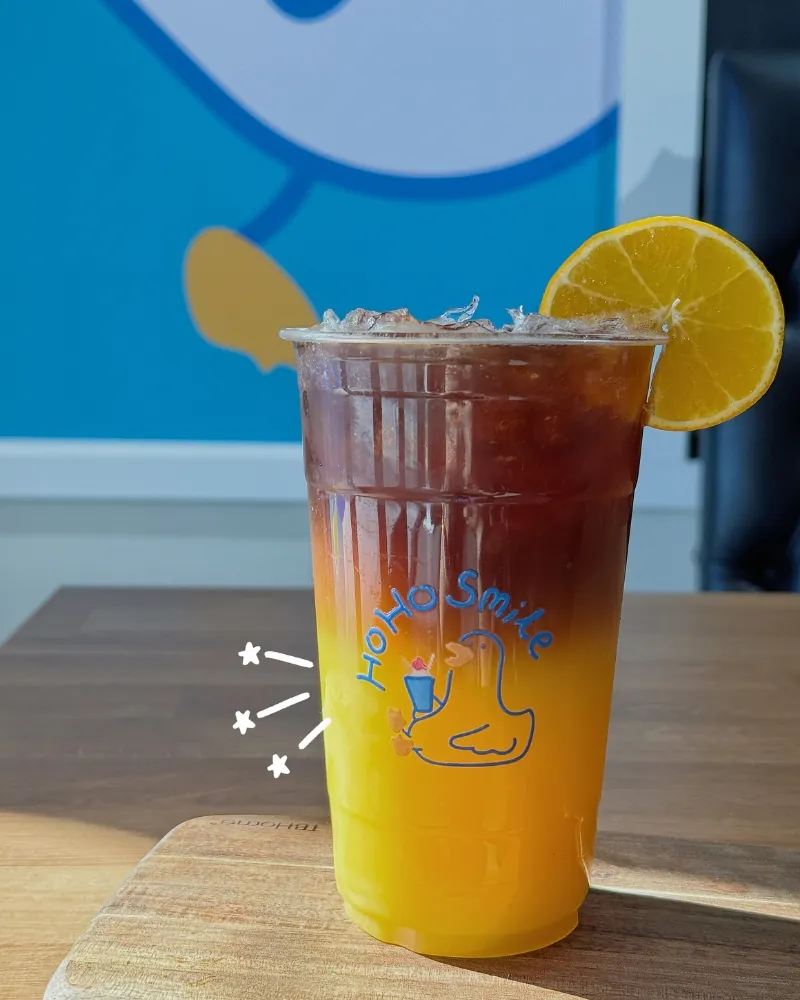 Layered orange black tea with a fresh orange slice at Hoho Smile, a Bubble Tea Store in Glendale